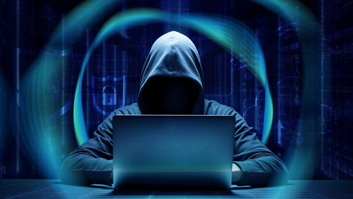 A dark, cloaked bad actor initiating an AI cyberattack