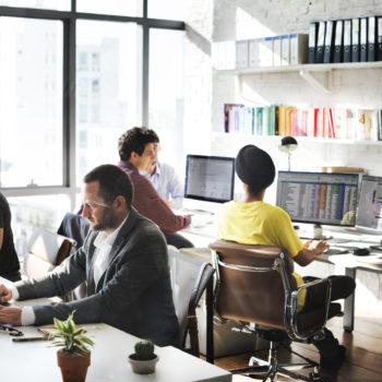 4 people working at desks